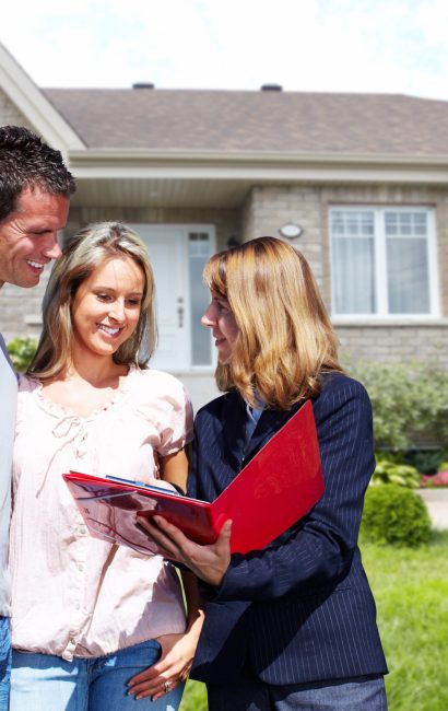 Real Estate agent woman near new house. Home for sale concept.